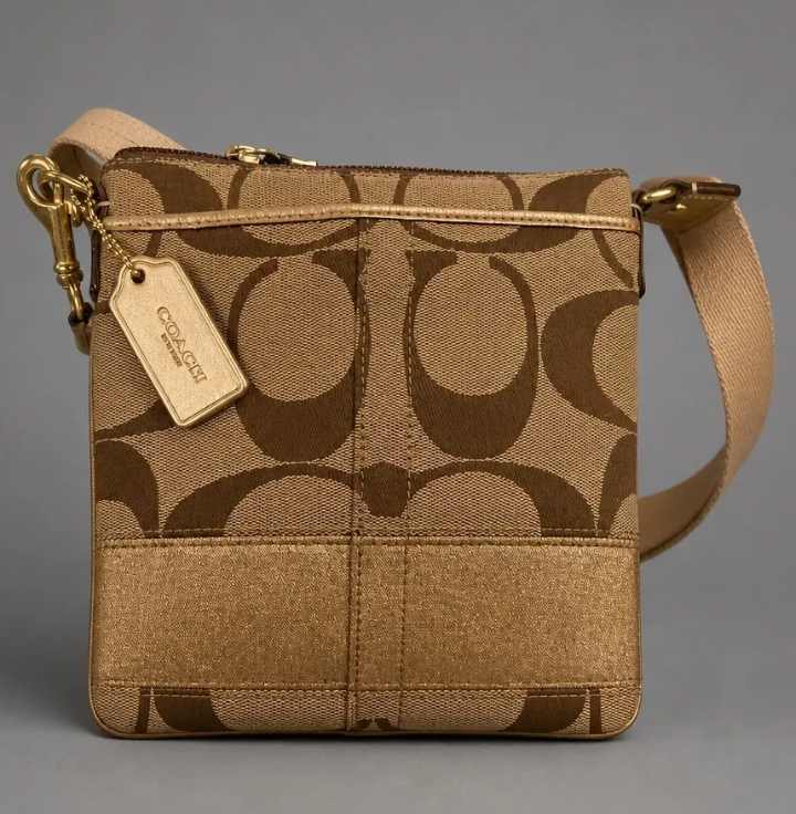Coach Signature Canvas Swingpack Crossbody with metallic gold stripe